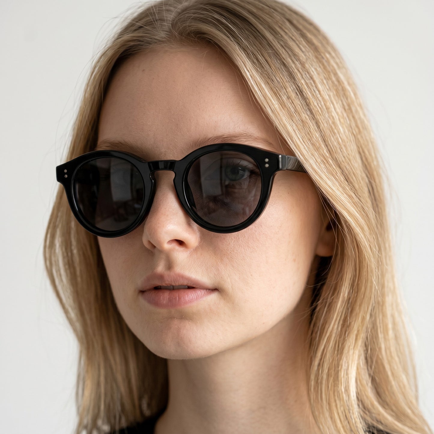 nadaraty eyewear Horus Darko - H 194 black round acetate sunglasses with dark tinted lenses and double dot embellishments.