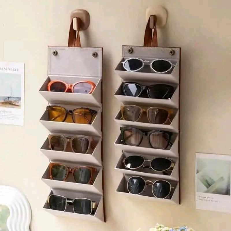nadaraty eyewear white hanging glasses organizer with 10 slots holding various sunglasses and reading glasses.