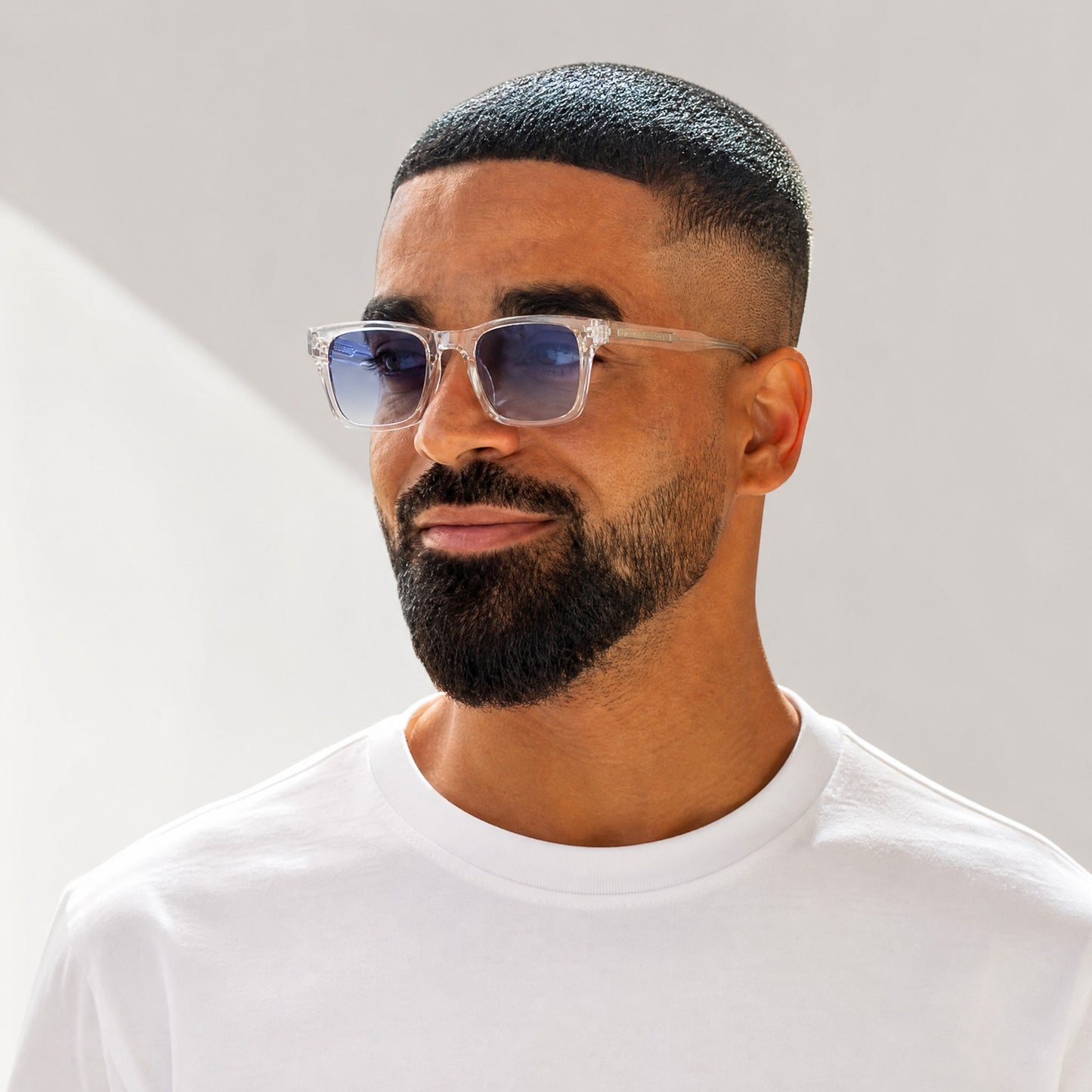 nadaraty eyewear Horus Dagger clear acetate rectangular sunglasses with blue gradient polarized lenses.