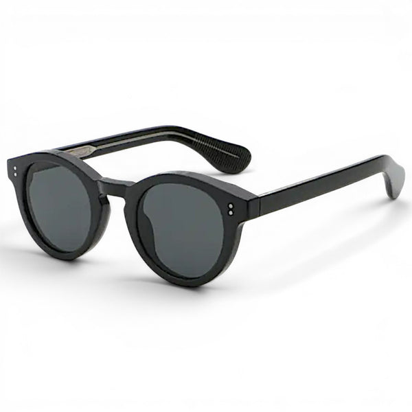 nadaraty eyewear Horus Darko H 194 black round sunglasses with dark grey lenses and silver stud details.