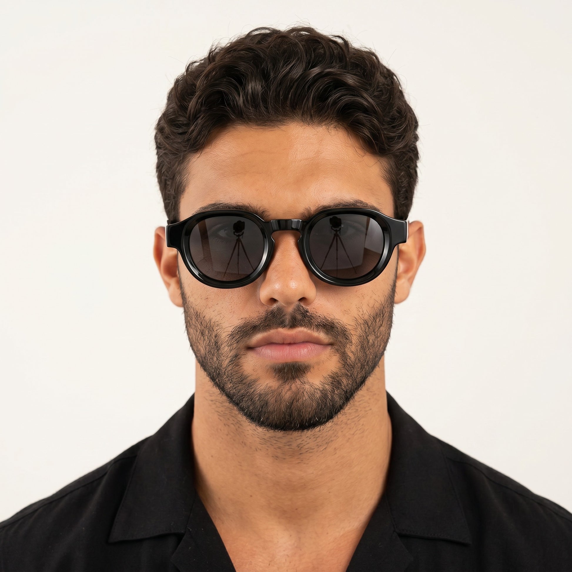A man wearing nadaraty eyewear Horus Pro H 178 black acetate sunglasses with a bold rounded frame design.