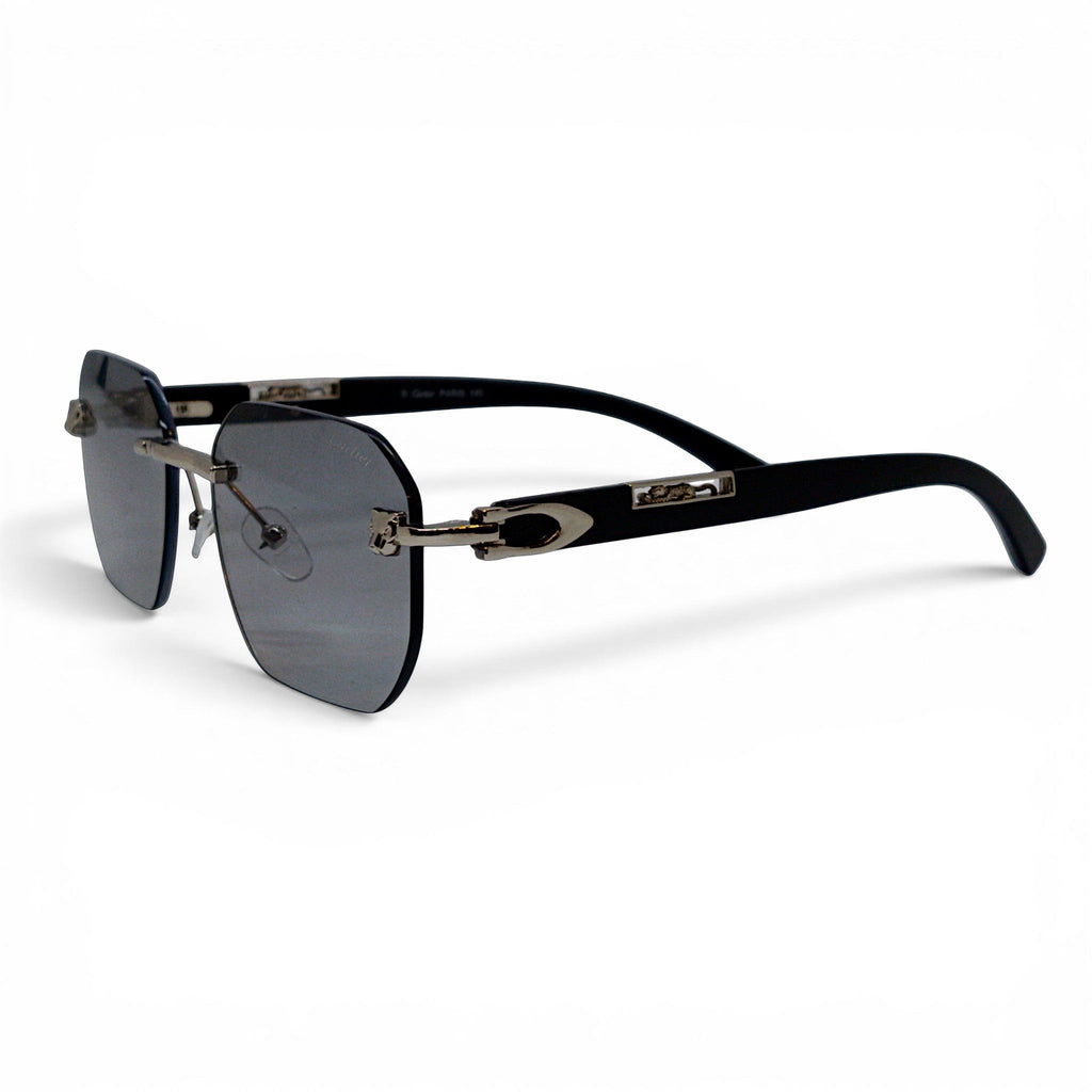 nadaraty eyewear Photocromic ctr 01 rimless sunglasses with dark grey lenses and silver accents on black arms.