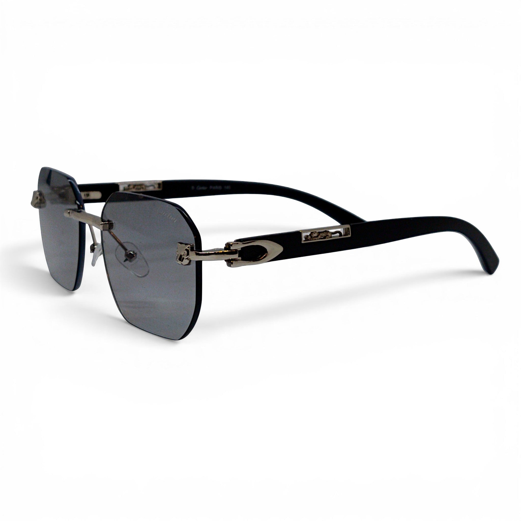 nadaraty eyewear Photocromic ctr 01 rimless sunglasses with dark grey lenses and silver accents on black arms.