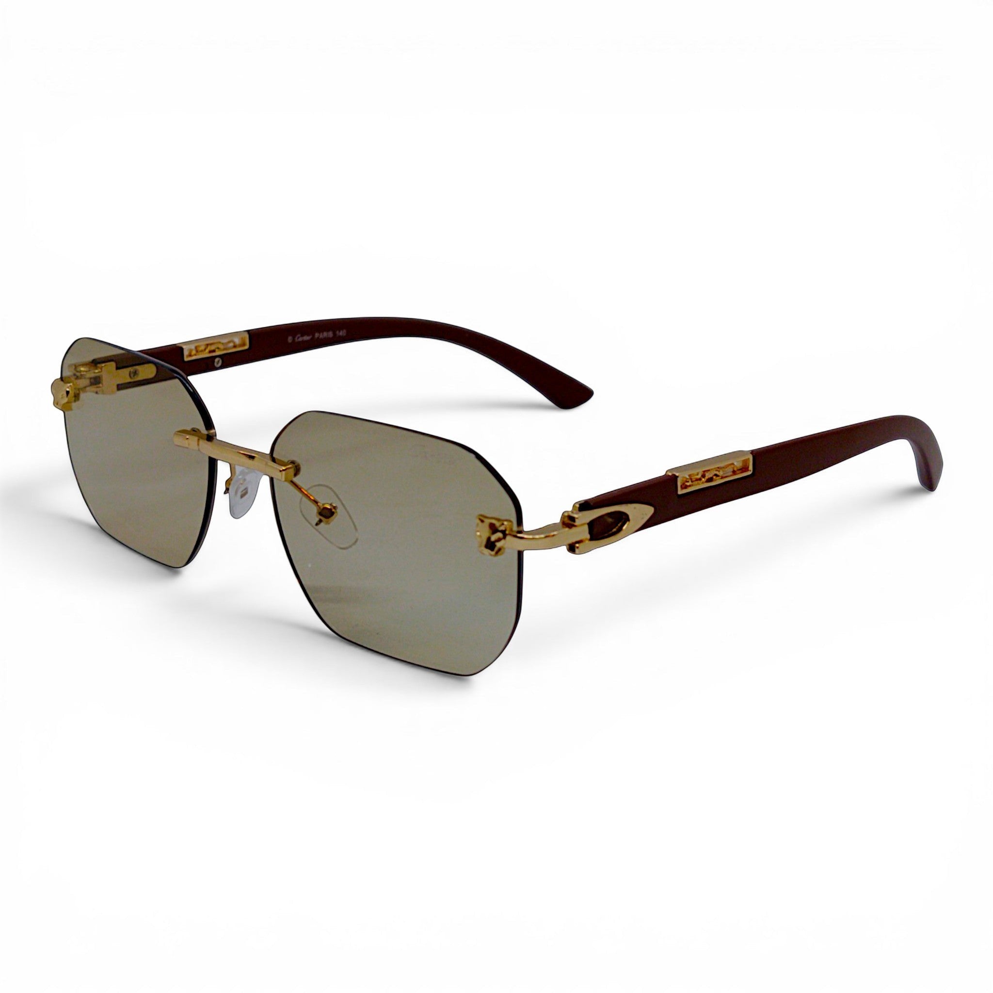 Nadaraty Eyewear rimless octagonal sunglasses with gold accents and brown temples. Photocromic lenses.