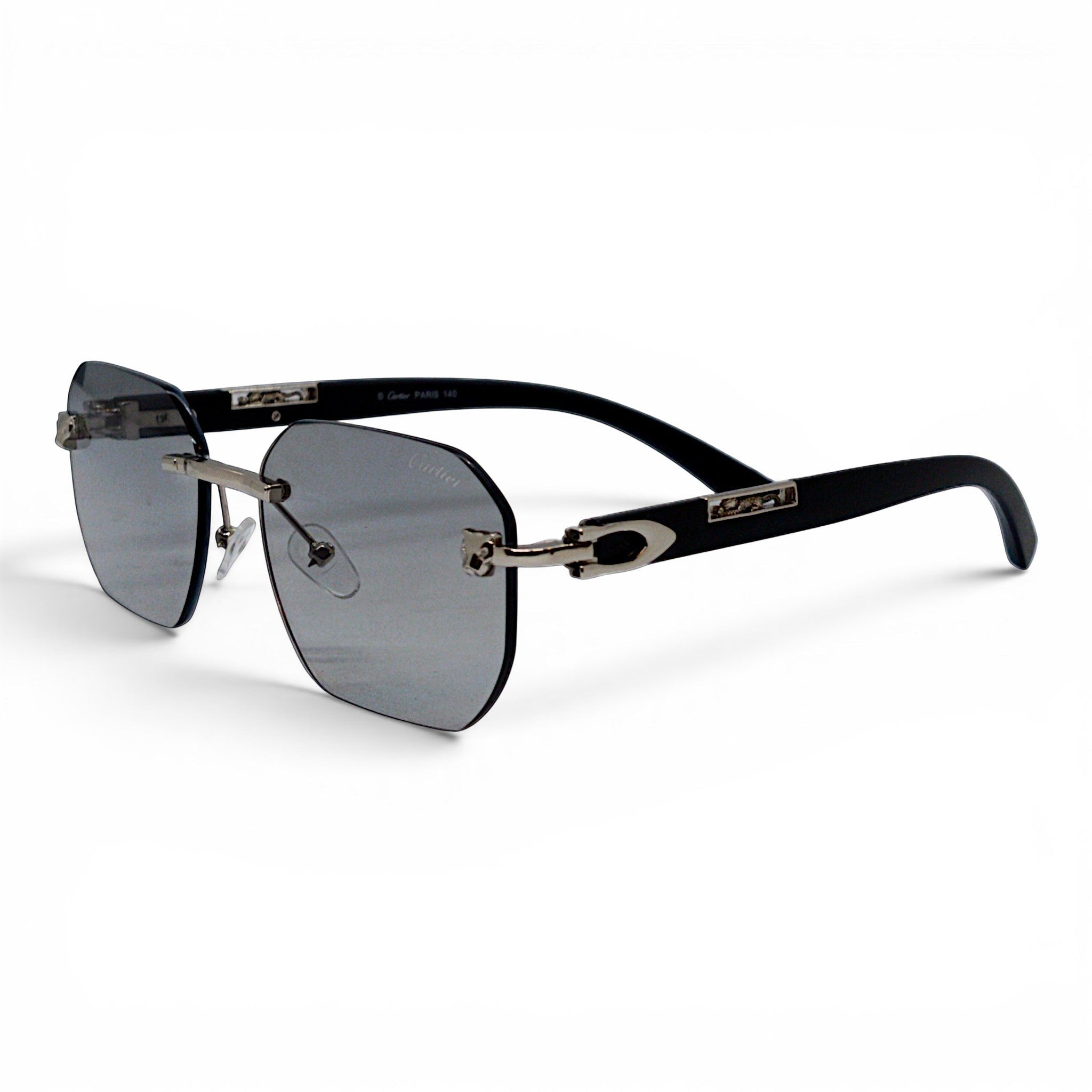 nadaraty eyewear Photocromic ctr 01 rimless sunglasses with silver accents and black arms.